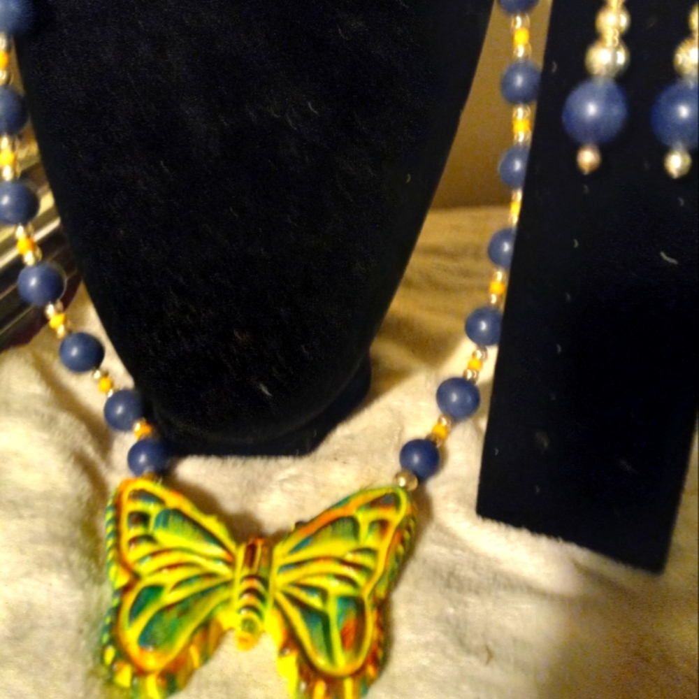 Used,not new 28 inch navy ball necklace with ceramic yellow butterfly& earrings
